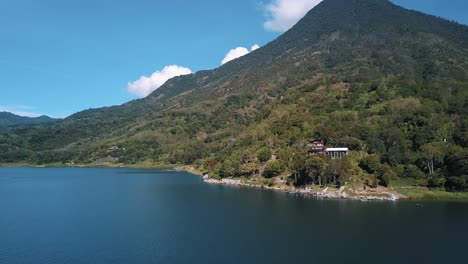 Drone-aerial-landscape-wide-view-of-a-volcano-and-Lake-Atitlan,-Guatemala