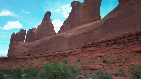 Wide-tilting-up-shot-of-the-rock-formations-along-the-Park-Avenue-Trail-in-Arches-National-Park,-Utah