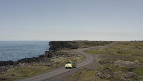 Aerial-of-car-traveling-on-rural-road-at-volcanic-coast-of-Snæfellsnes-Peninsula