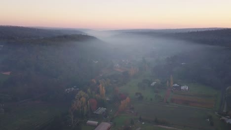 Early-morning-fog-and-smoke-from-bushfires-covering-houses-in-countryside-Western-Australia-at-sunrise