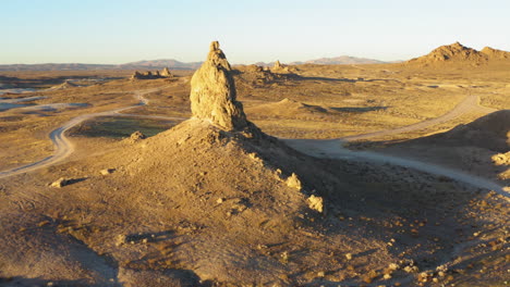 Aerial-point-of-interest-shot-of-a-big-rock-formation-of-the-Trona-Pinnacles-during-the-sunrise