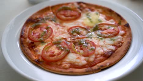 Pizza-Margherita-on-a-white-plate-with-soft-window-light-shining