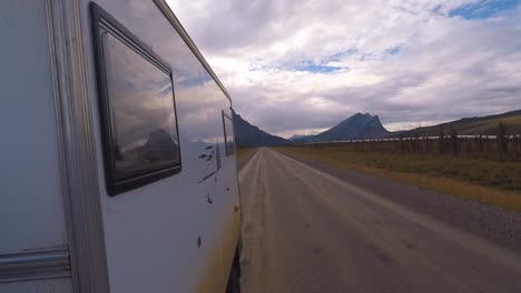 Rear-view-from-the-side-of-a-motorhome-driving-on-the-Dalton-Highway-close-to-the-Alaska-Pipeline
