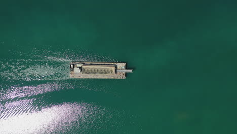 Top-view-of-industrial-boat-filled-with-sand-sailing-in-the-water
