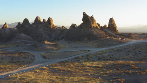 Fast-aerial-view-flying-towards-the-Trona-Pinnacles-in-the-Mojave-Desert-during-a-bright-yellow-sunrise