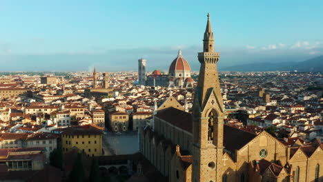 Flying-over-rooftops-and-spires-of-Florence,-Italy