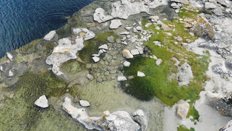 Drone-flying-over-rocky-coastline-of-Gotland-Island,-Sweden