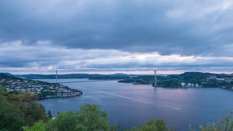 View-from-Lyderhorn-towards-the-Askoy-bridge-as-daylight-fades-behind-heavy-clouds-streaking-across-the-sky-in-time-lapse