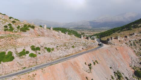 Forward-moving-aerial-over-the-curved-and-winding-roads-on-deserted-mountains-of-Spinalonga-island-in-north-eastern-Crete