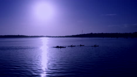 People-Kayaking-On-The-Lake-During-Blue-Hour-With-Full-Moon-On-The-Background-In-Auckland,-New-Zealand