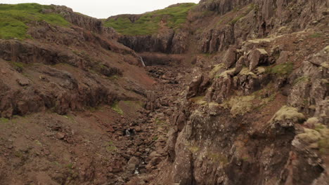Westfjords-of-Iceland,-tracking-drone-shot-through-rocks