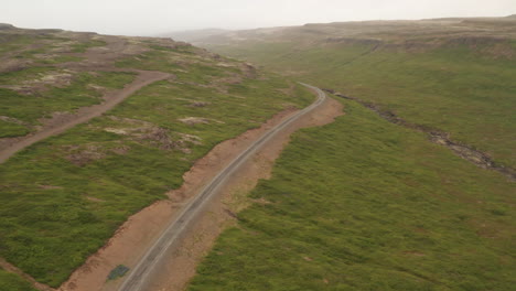 Road-62-passing-through-Iceland-westfjords,-long-drone-shot