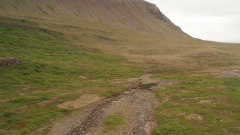 Steep-hills-of-Iceland's-westfjords-on-cloudy-day,-drone-shot