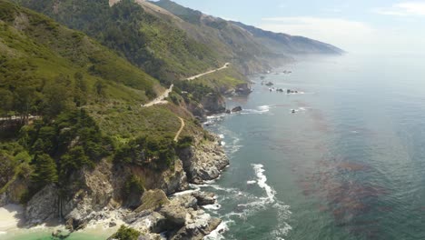 4K-Aerial:-Pan-Up-Reveals-Dramatic-Coastline-in-California's-Big-Sur-with-McWay-Falls-Waterfall-in-Background