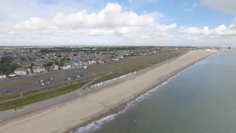 Aerial-Drone-Footage-of-the-Beautiful-Beach-Huts-on-the-coast-of-Gorleston-On-Sea,-Norfolk