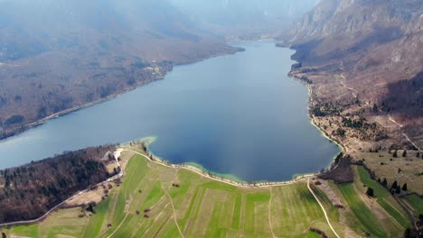 Mesmerizing-aerial-view-of-Lake-Bohinj-in-the-heart-of-the-Triglav-National-Park,-embraced-by-the-Julian-Alps-in-peaceful-and-pristine-nature