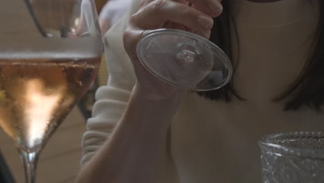 Close-up-of-a-woman-drinking-a-sparkling-wine