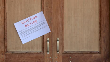 Eviction-notice-sticking-on-the-entrance-door-of-the-house