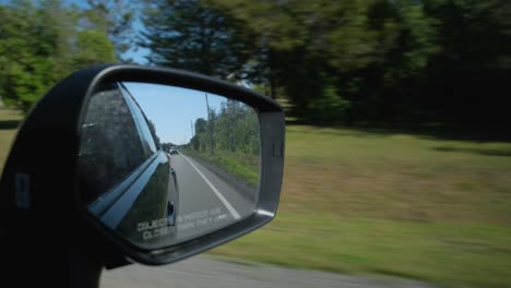 View-of-the-passenger-mirror-in-a-moving-car