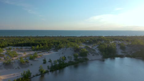 Drone-flying-over-the-sand-dunes-and-the-Ontario-lake-in-Sandbanks