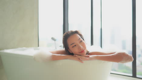 A-beautiful-young-woman-totally-relaxes-while-taking-a-bubble-bath