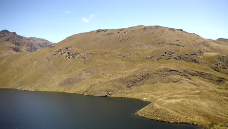 Drone-flying-over-Andes-mountains-and-lake-in-Parque-Nacional-Cajas,-Ecuador