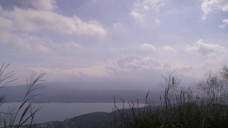 Beautiful-view-out-on-Silhouette-of-Mt-Fuji-and-Lake-Yamanaka-with-tall-grass-Timelapse