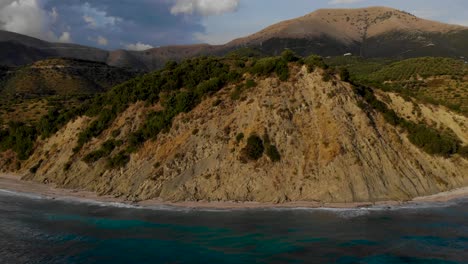 Mountains-and-rocky-hills-on-seaside-of-Southern-Albania-bordered-by-blue-azure-sea-water