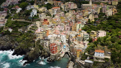 Italian-Village-of-Riomaggiore,-High-Aerial-View-of-Coast