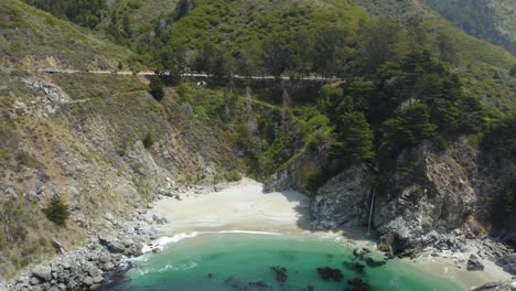 Drone-Flies-Over-McWay-Falls---Iconic-Destination-Along-California's-Highway-1-in-Big-Sur