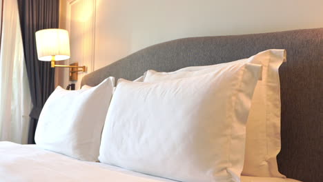 Close-up-tilt-down-on-a-luxury-hotel-suite-bed