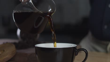 Pouring-freshly-brewed-coffee-into-a-cup
