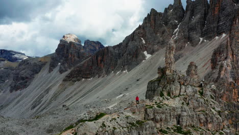 Man-stands-alone-in-Rugged-Dolomite's-Landscape,-Italy