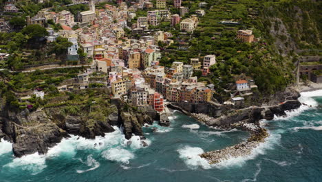 Riomaggiore-Aerial-pullback-establishing,-Italy-coastline