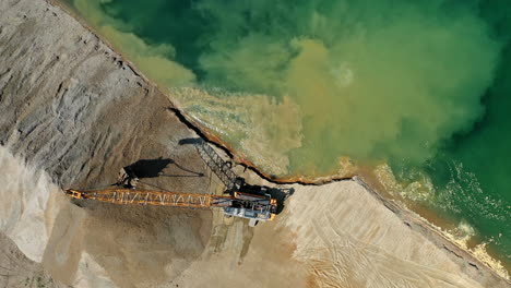 Aerial-top-down-view-of-an-excavator-loading-crushed-stone