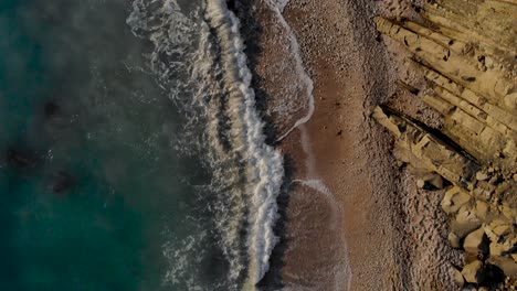 Sea-waves-splashing-on-cliffs-and-pebbles-of-beautiful-coastline-in-Mediterranean