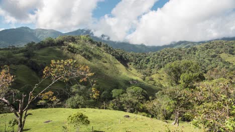 Beautiful-4k-timelapse-of-clouds-moving-fast-in-a-green-field-with-mountains,-shot-in-Colombia-valley
