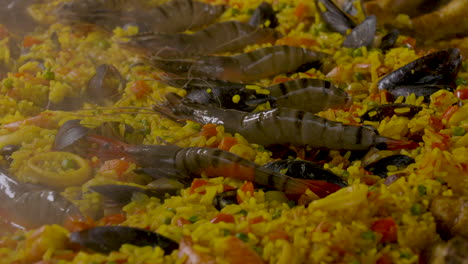 Shot-of-the-boiling-hot-paella-pan-with-tiger-shrimps-and-mussels-as-ingredients-in-the-saffron-rice-dish