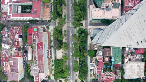 Spectacular-high-aerial-flight-past-tall-torre-mayor-tower,-chapultepec-uno,-BBVA-and-reforma-skyscrapers-in-downtown-financial-district-directly-above-Paseo-de-la-reforma-avenue,-drone-tracking