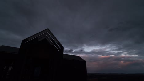 A-time-lapse-of-a-sunset-over-a-house-with-a-steeple