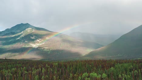 Beautiful-Ascending-Aerial-View-of-Canadian-Rocky-Mountains-with-Rainbow-in-4K---Nature,-Forest-and-Mountain-Landscape---Jasper,-Alberta