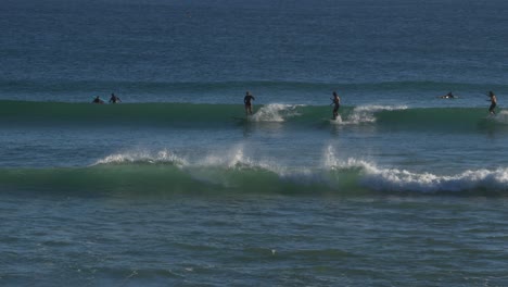Surfers-Riding-On-The-Blue-Waves-In-Snapper-Rocks-Beach---Surfing-Adventure-In-Gold-Coast,-QLD,-Australia---wide-shot
