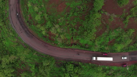 drone-top-shot-of-container-truck-turning-on-mountain-road-Indian-malvan