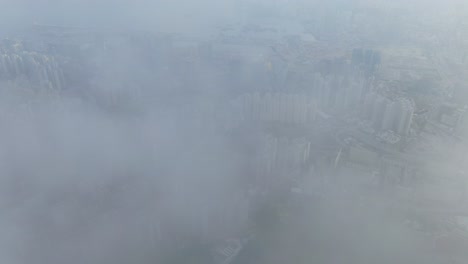Hong-Kong-bay-and-skyline-with-skyscrapers,-high-altitude-wide-shot-with-early-morning-mist