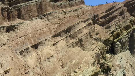 Volando-Hacia-Arriba-Y-Hacia-Afuera-De-Las-Formaciones-Rocosas-En-Capas-Que-Forman-El-Valle-En-La-Cuenca-Del-Arco-Iris-Parte-Del-Desierto-De-Mojave