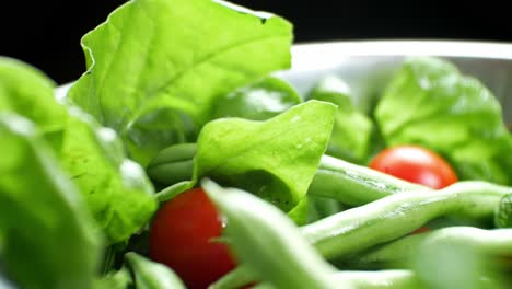 Shallow-focus-healthy-fresh-green-spinach-leaf-cucamelon-cherry-tomato-salad-bowl-closeup-slow-right-dolly