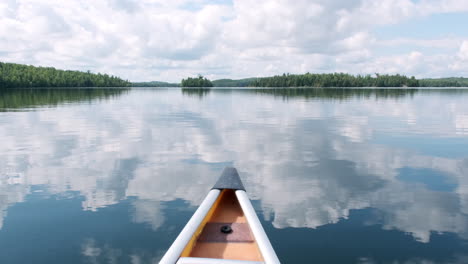 Glassy-Lake-Canoe-POV-With-Sky-Reflection