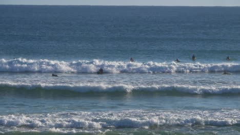 Surfers-enjoying-and-riding-the-waves---Gold-Coast-QLD-Australia