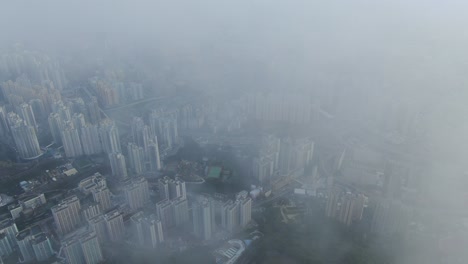 Hong-Kong-bay-and-skyline-with-skyscrapers,-high-altitude-wide-shot-with-early-morning-mist