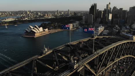 Top-down-view-of-harbor-bridge,-Opera-House-and-Sydney-cityscape